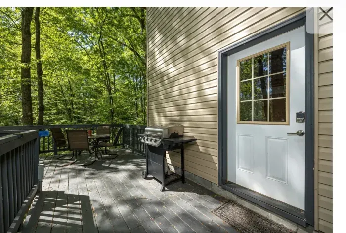 Sunny wooded deck with BBQ and dining set—your private outdoor retreat.