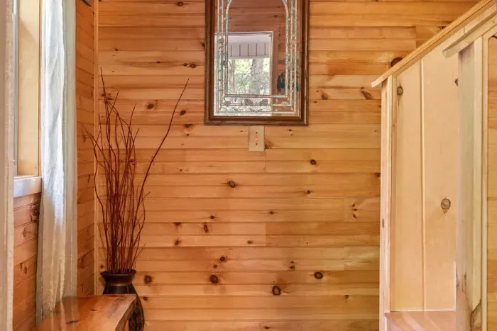 Cozy wood-paneled nook with rustic cabin charm and natural light