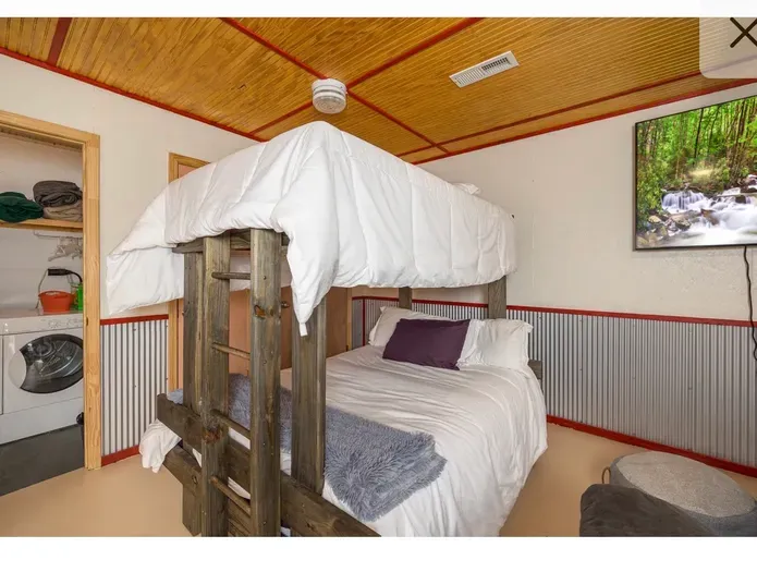 Cozy bunk room with TV and in-room laundry—sleep more in style.