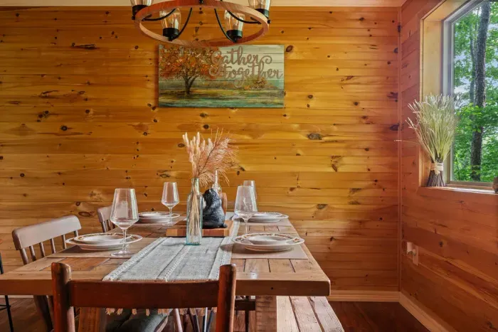 Rustic wood dining nook with forest views and cozy cabin charm