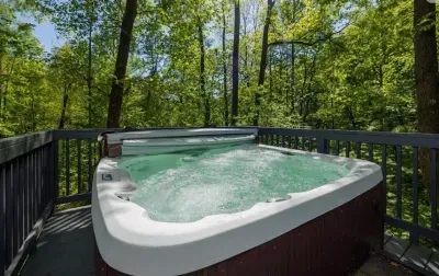 Private forest-view hot tub on deck — soak under the trees in peace.