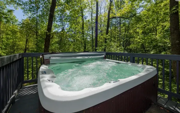 Private forest-view hot tub on deck — soak under the trees in peace.