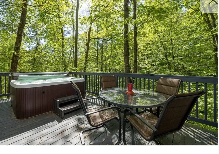 Secluded forest deck with hot tub and dining for four