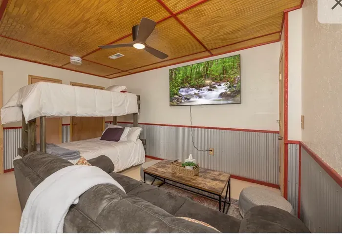 Cozy bunk room with sofa lounge and big TV—perfect for families
