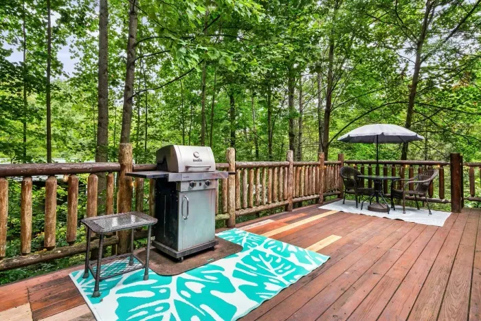 Outdoor seating and gas grill near kitchen entrance 