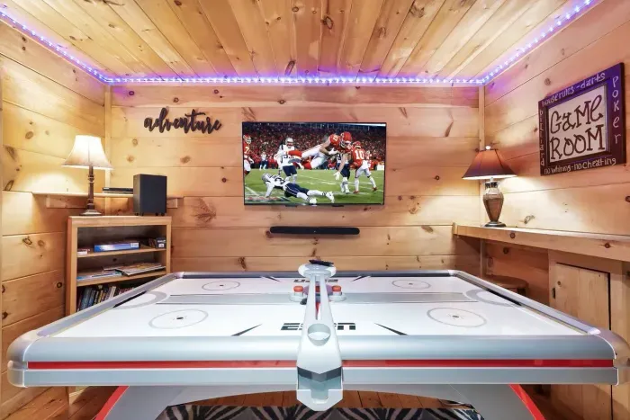 Game room with big screen steaming TV, sound bar, arcades, wall chess, and couch for viewing the games or your favorite movies