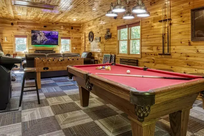 Game room with billiards, arcade, foosball, wet bar, poker table, and movie watching area 