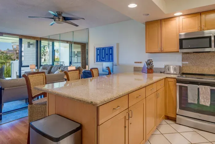 Granite countertops, stainless steel appliances, and bar seating 