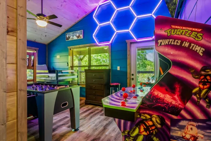 Vibrant game loft with arcade, foosball, bunks & deck views