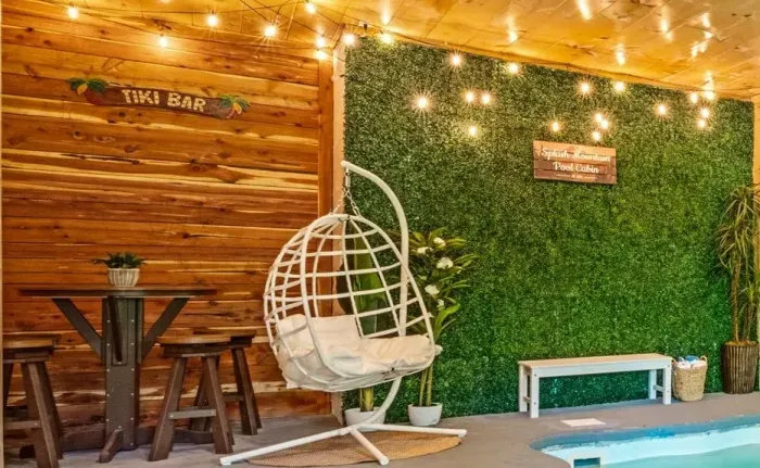 Cozy poolside lounge with tiki bar, egg chair & twinkle lights