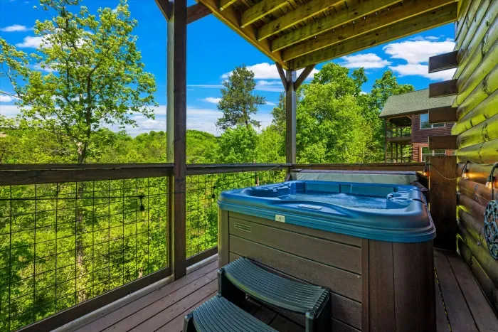Covered deck with private hot tub and serene forest views