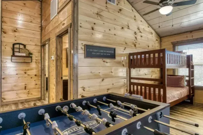 Upstairs loft with bunk beds, arcades, and foosball