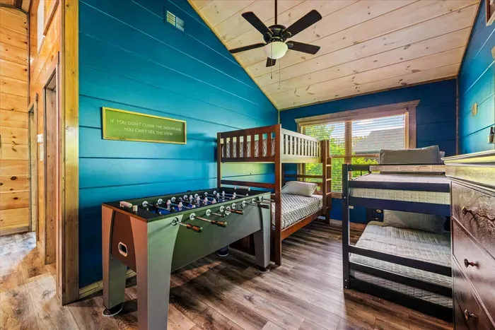 Kids’ bunk room with foosball, vaulted ceiling and sunny woodland views