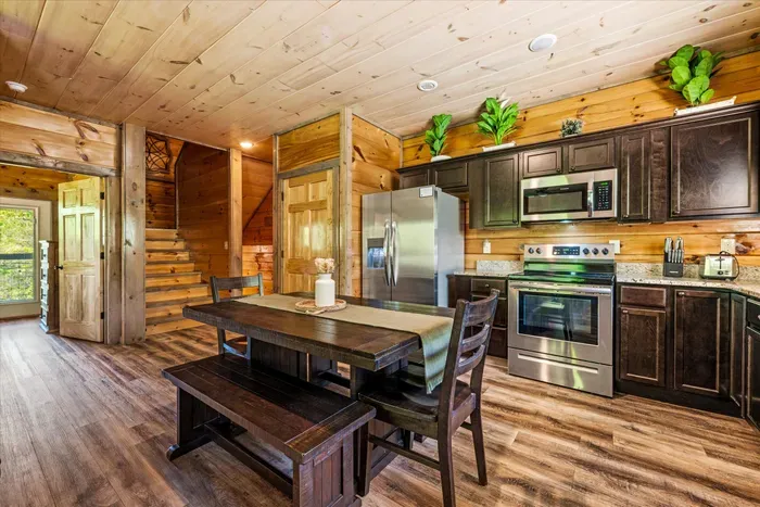 Rustic-chic cabin kitchen with stainless appliances and spacious dining