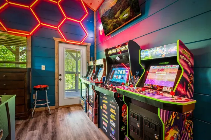 Neon-lit arcade room with classic games and deck access—family fun hub