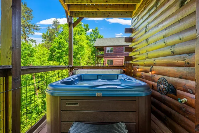 Private covered deck with hot tub and forest views—pure relaxation.