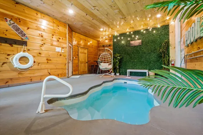 Private indoor pool oasis in a cozy cabin with swing chair