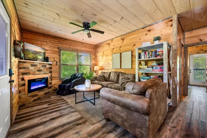 Rustic cabin living room with fireplace, games, and massage chair