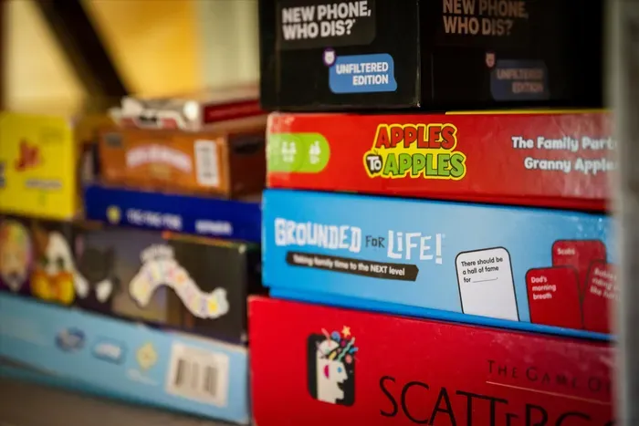 Shelf stocked with board games for family fun and cozy nights in.