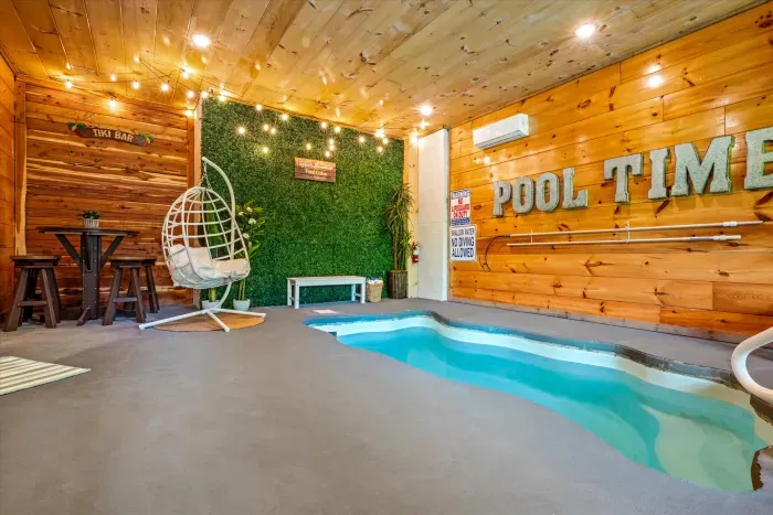 Cozy indoor plunge pool with string lights and tiki-bar vibe