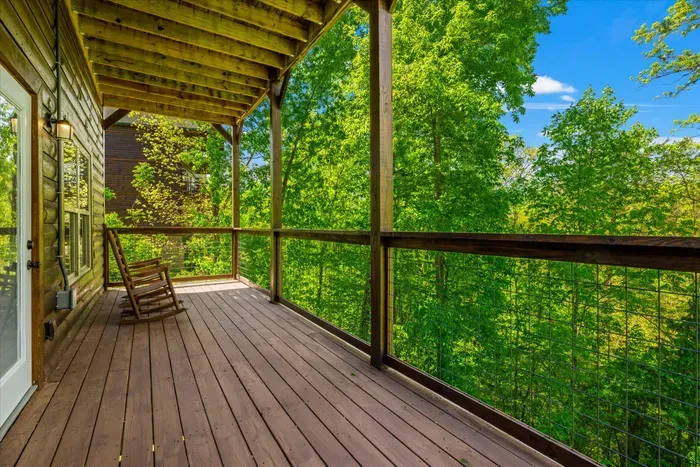 Covered treetop deck with rocking chairs—quiet forest escape