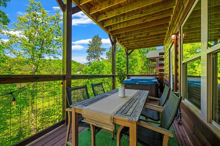 Covered deck with forest views, alfresco dining & private hot tub