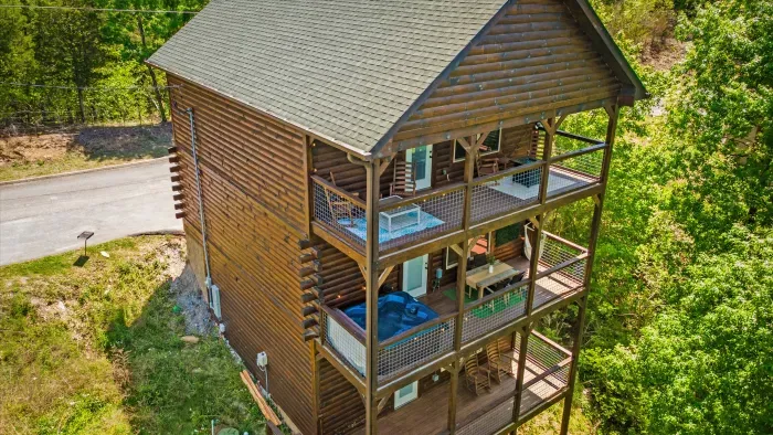 Three-story log cabin with hot tub, roomy decks, and forest views