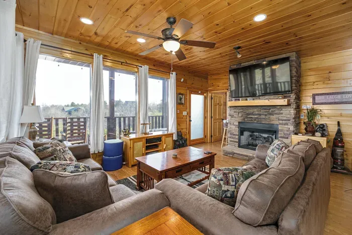 Movie area with fireplace, sleeper sofas and deck access