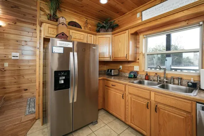 Full size kitchen opens to dining area with bar seating 
