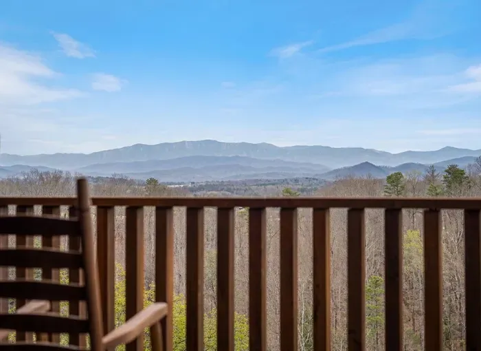 Sweeping mountain vistas from a private deck with rocking chair