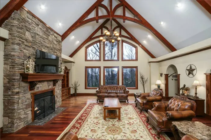 Family room with cherrywood floors, stacked stone fireplace and vaulted ceilings 