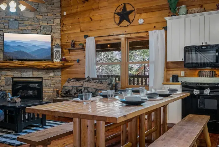 Rustic cabin great room with stone fireplace and generous dining