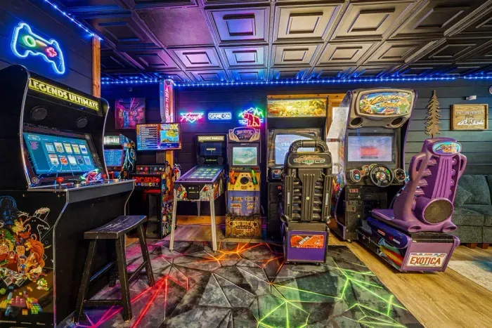 Retro arcade lounge with racing simulators, pinball, and neon vibes