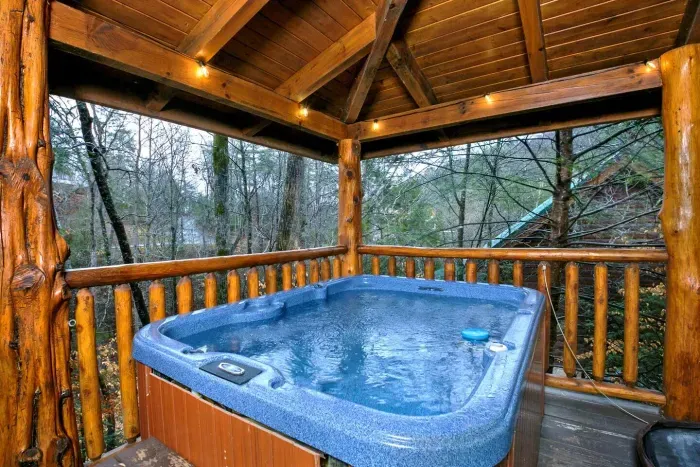 Hot tub with two hammocks, cafe lighting, views, and additional seating 