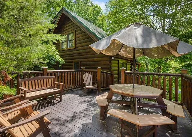 Shaded forest-view deck with picnic table and ample seating