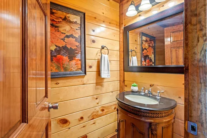 Cozy rustic powder room with warm wood finishes and charming details