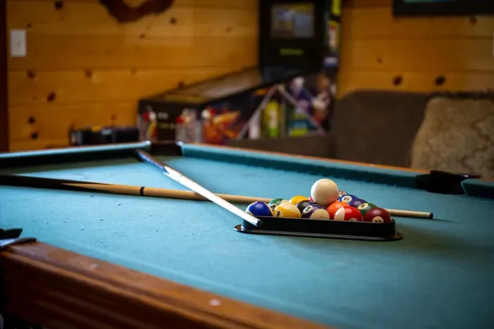 Cozy game room with pool table and arcade fun for relaxing nights in