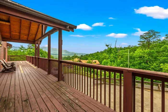 Spacious covered deck with rocking chairs and peaceful mountain views