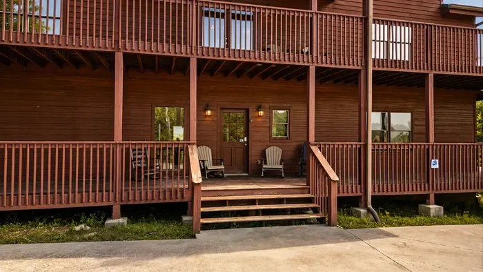 Welcoming rustic lodge with spacious covered porches and cozy entry seating