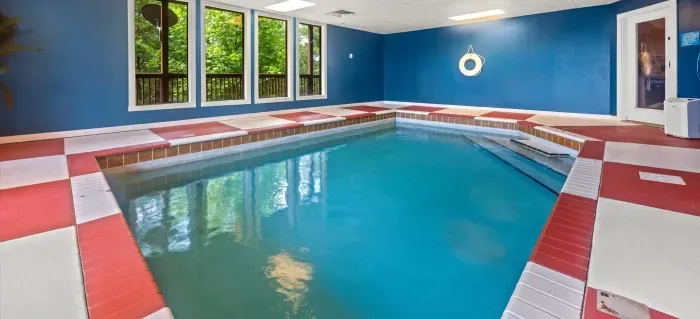 Private indoor pool with natural light and peaceful wooded views