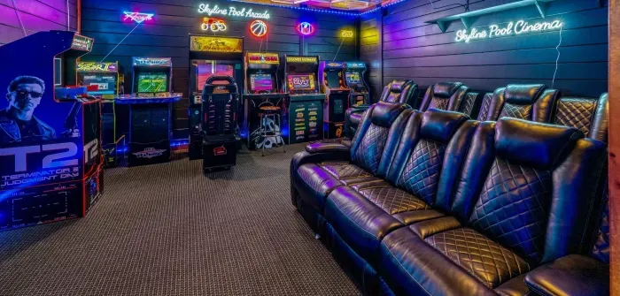 Private arcade theater with retro games, neon lights, and luxe recliners