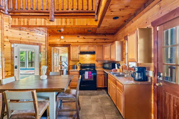 Rustic cabin kitchen with lofted ceilings and cozy dining space