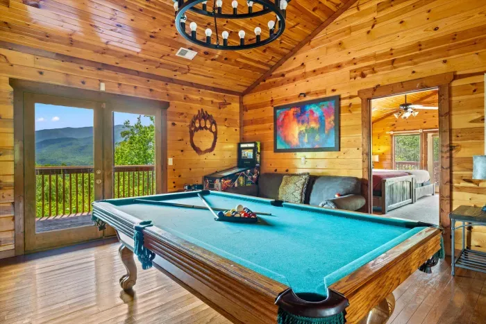 Rustic game room with pool table and stunning mountain-view balcony