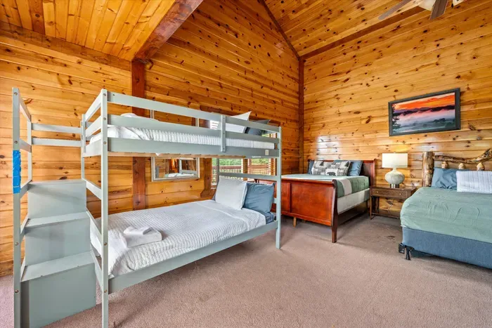 Cozy wood-paneled bunk room with space for the whole group