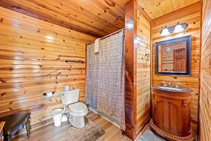 Cozy rustic bathroom with wood finishes and charming cabin style