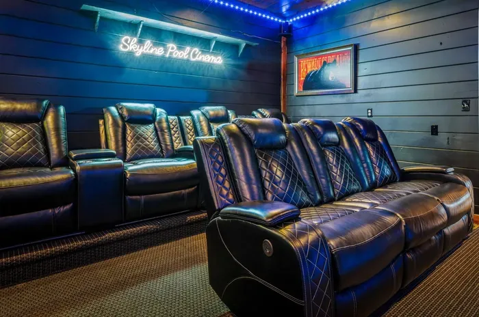 Private home theater with luxe recliners and cinematic LED ambiance