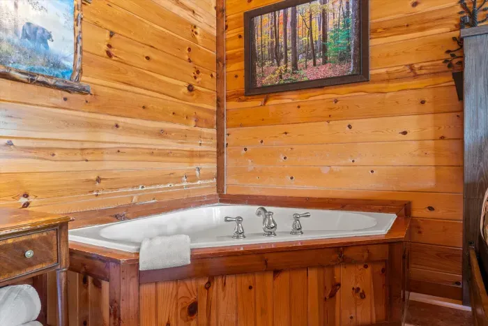 Rustic cabin bathroom with cozy corner soaking tub