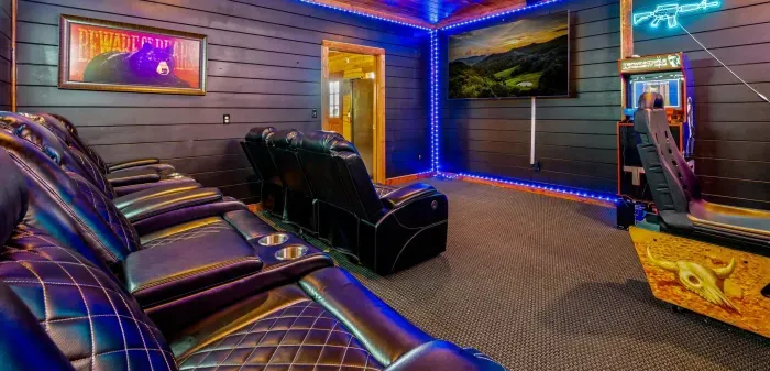 Private theater room with leather recliners, LED lighting & arcade fun