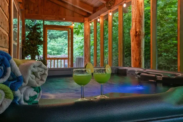 Private screened hot tub with forest views and cozy cabin ambiance
