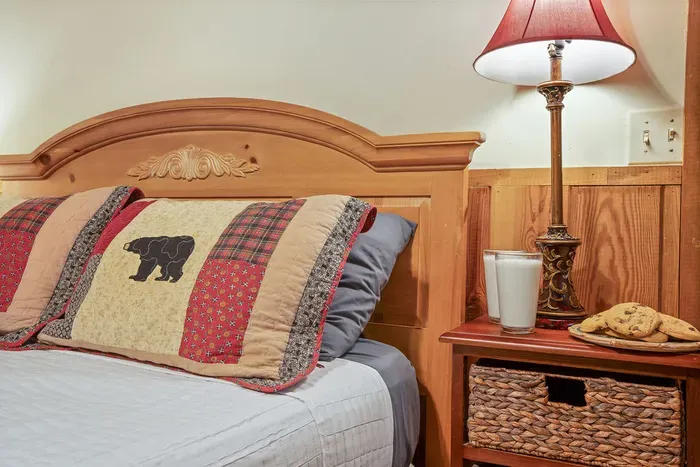 Cozy rustic bedroom with warm wood accents and thoughtful bedside touches